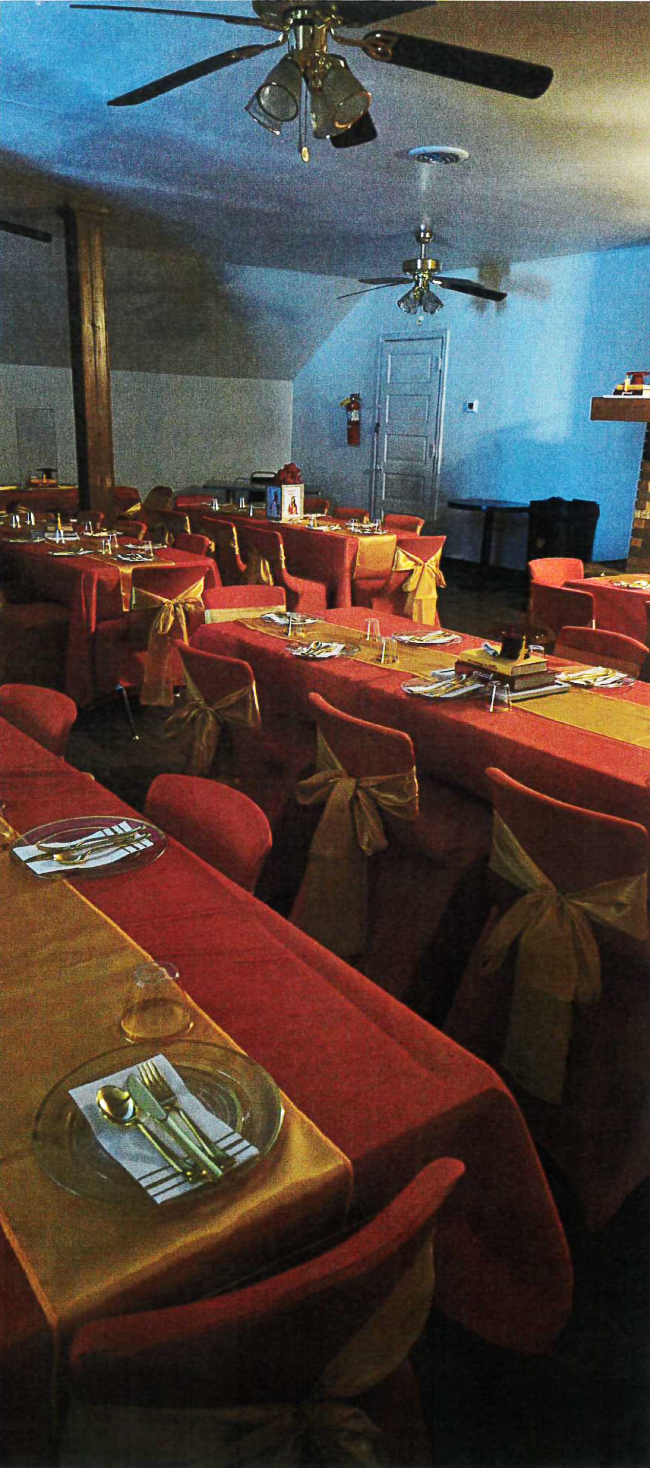 The banquet room set with linens and chair sashes for an event